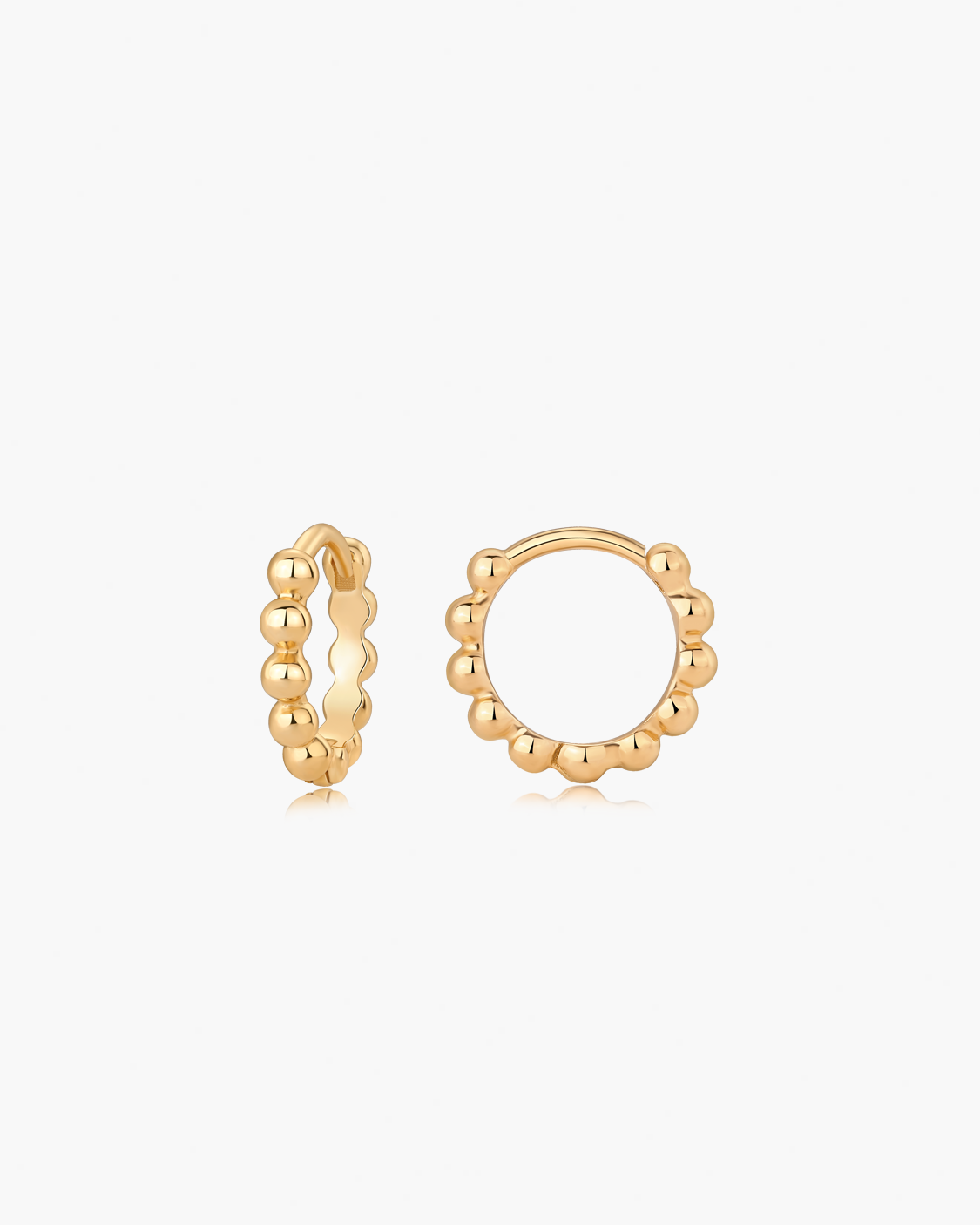 Gold hoop earrings on a white background