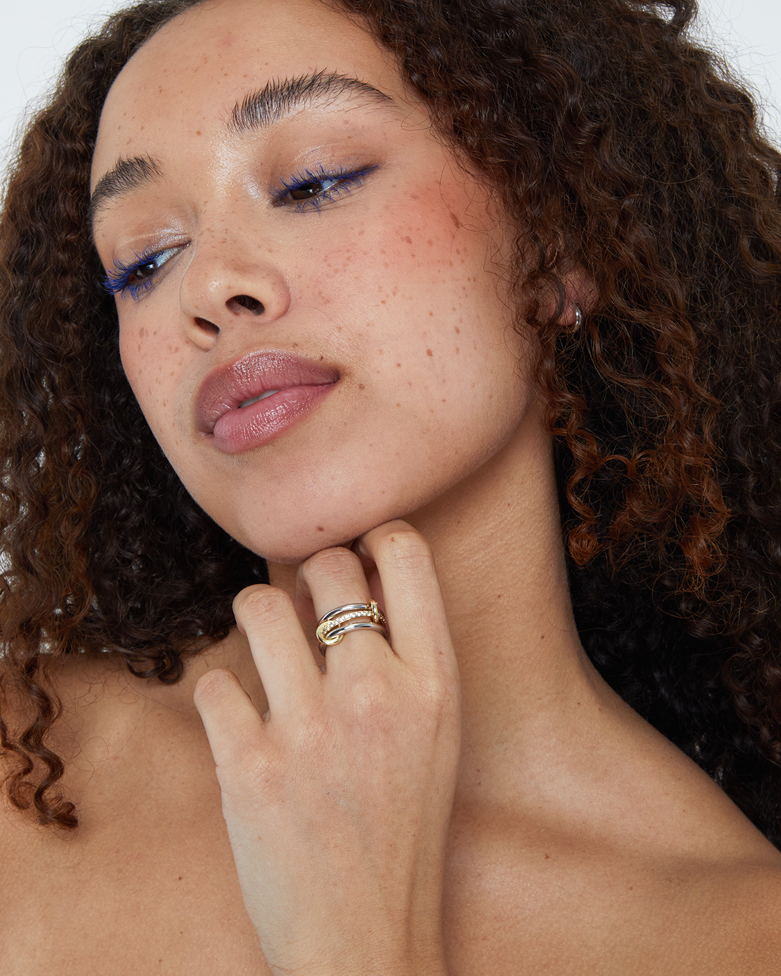 Woman with curly hair wearing pave ring 