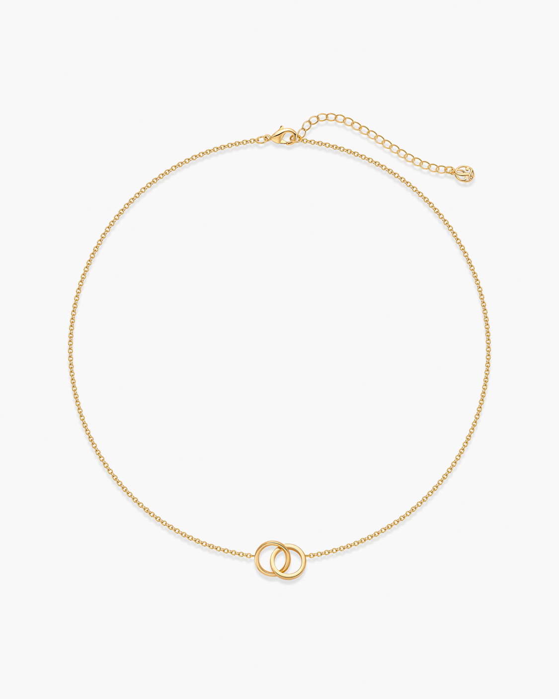 Gold necklace with a small interlocking pendant on a white background