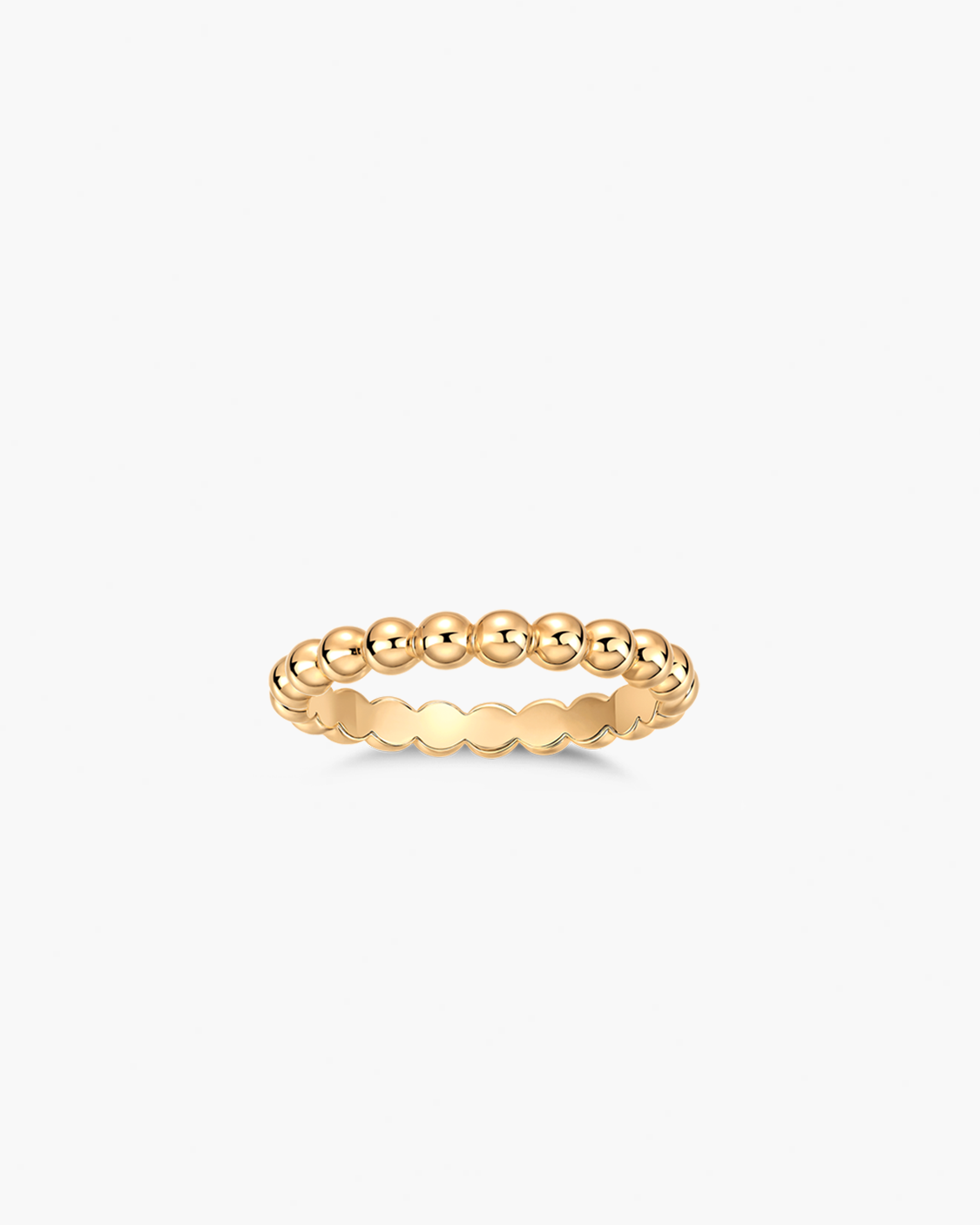 Gold beaded ring on a white background