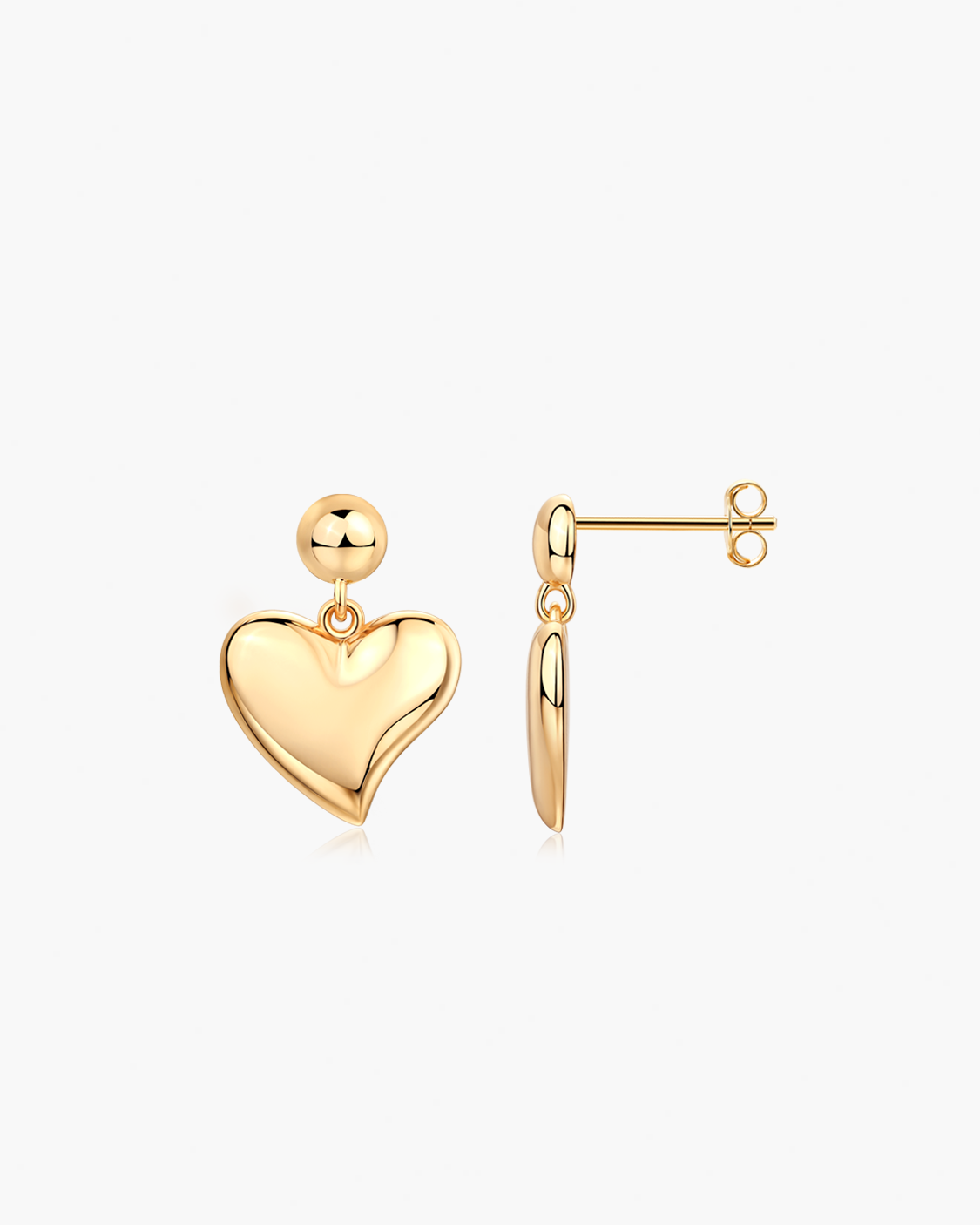 Gold chunky heart drop earrings on white background