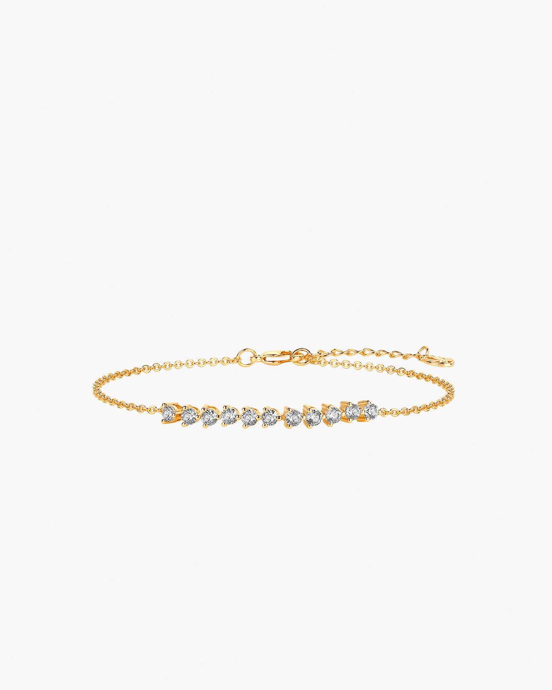 Gold bracelet with clear stones on a white background