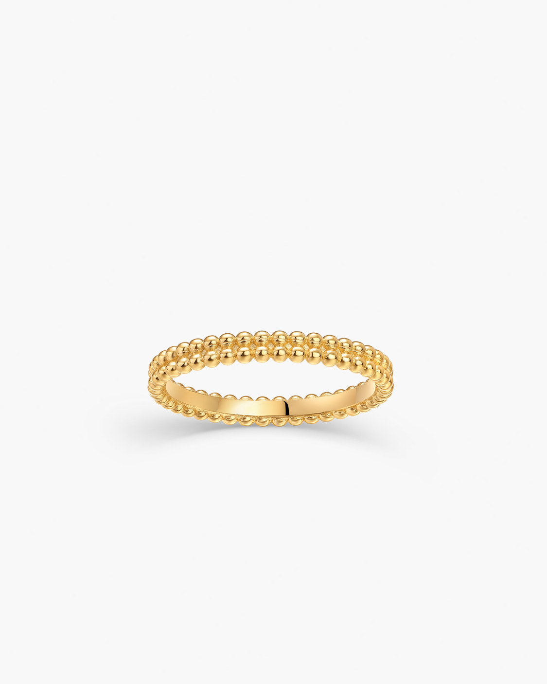 Gold ring with a textured band on a white background