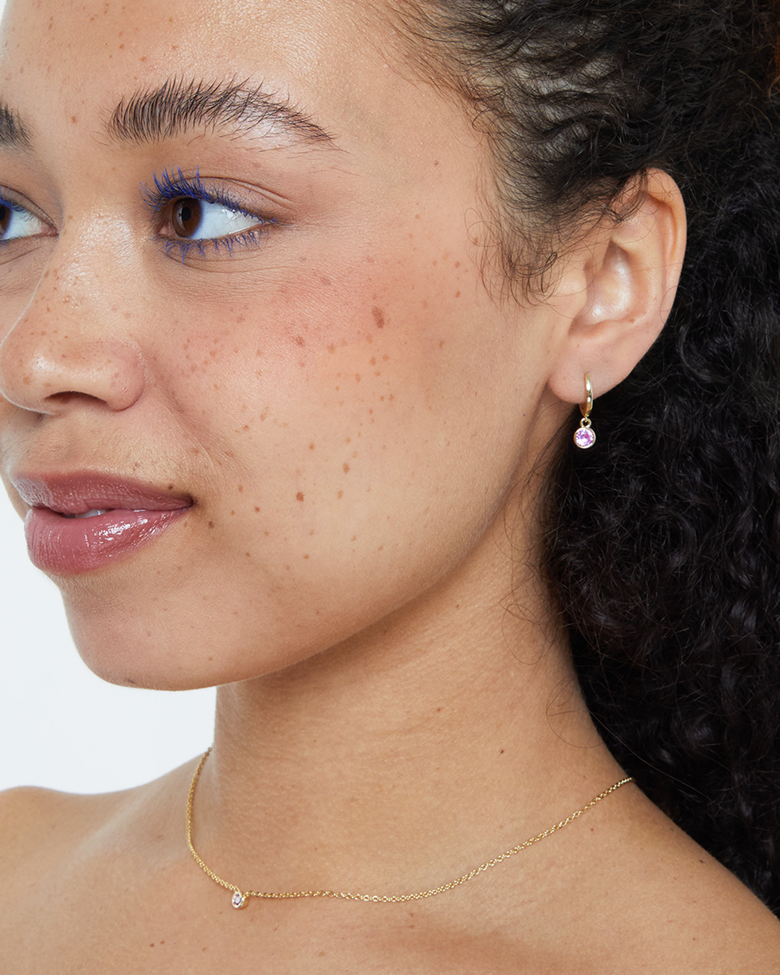 model wearing pink bezel drop earring