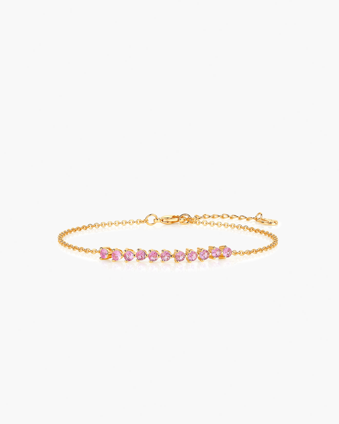 Gold bracelet with pink gemstones on a white background