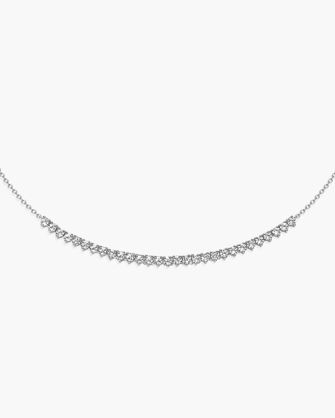Delicate silver necklace with small diamonds on a white background