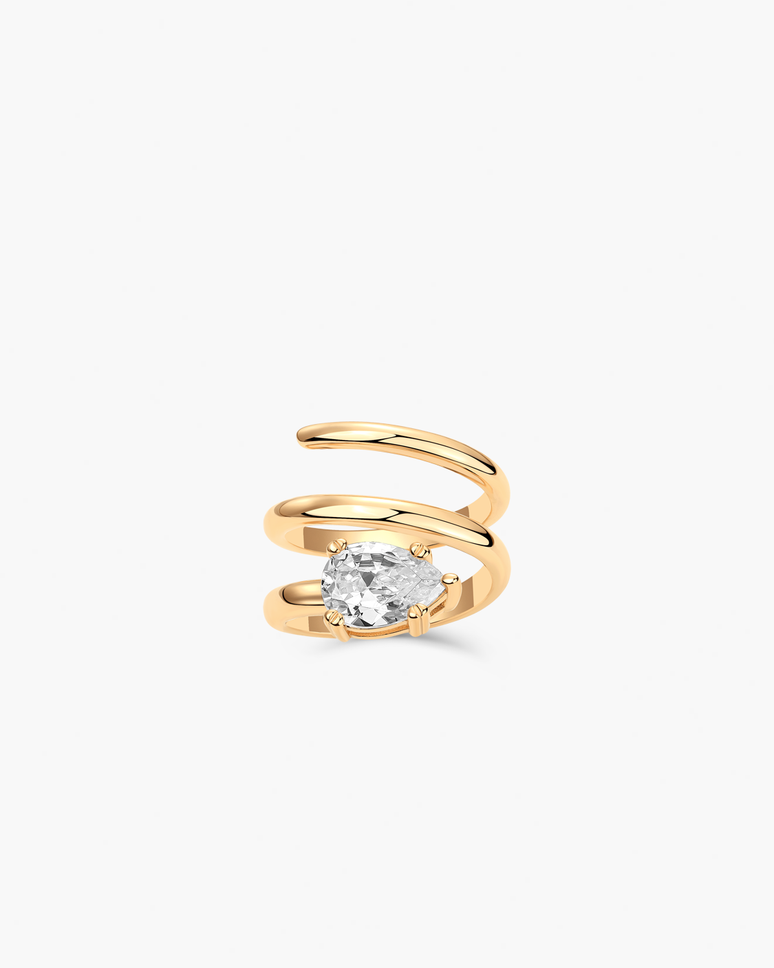 Gold spiral ring with a clear tear drop gemstone on a white background