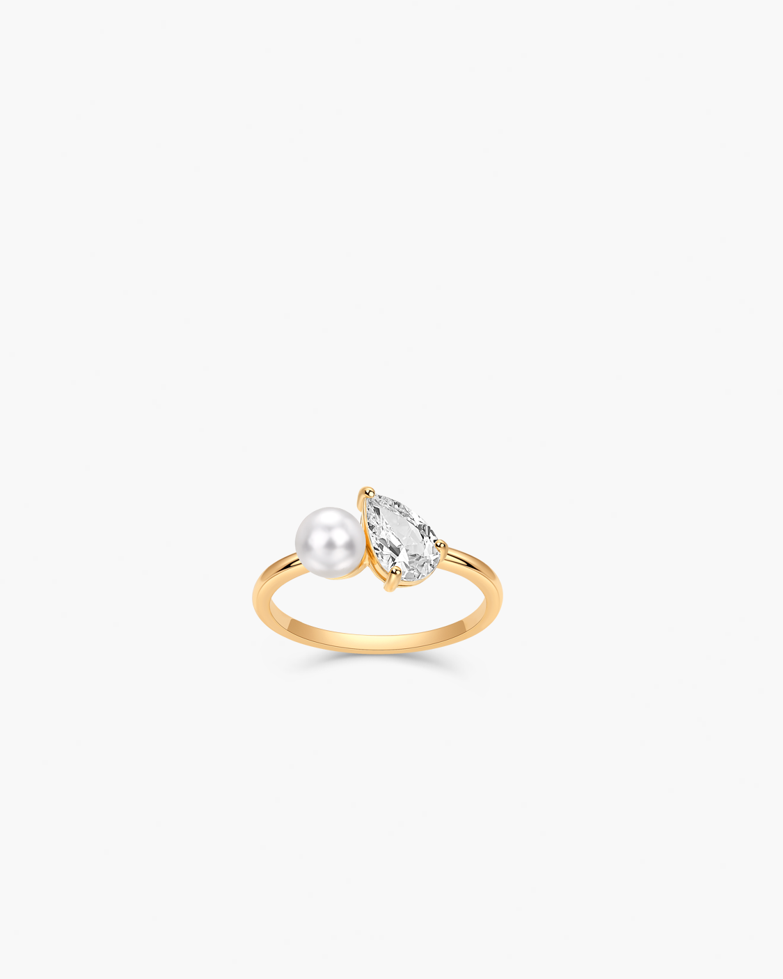 Gold ring with a pearl and clear gemstone on a white background