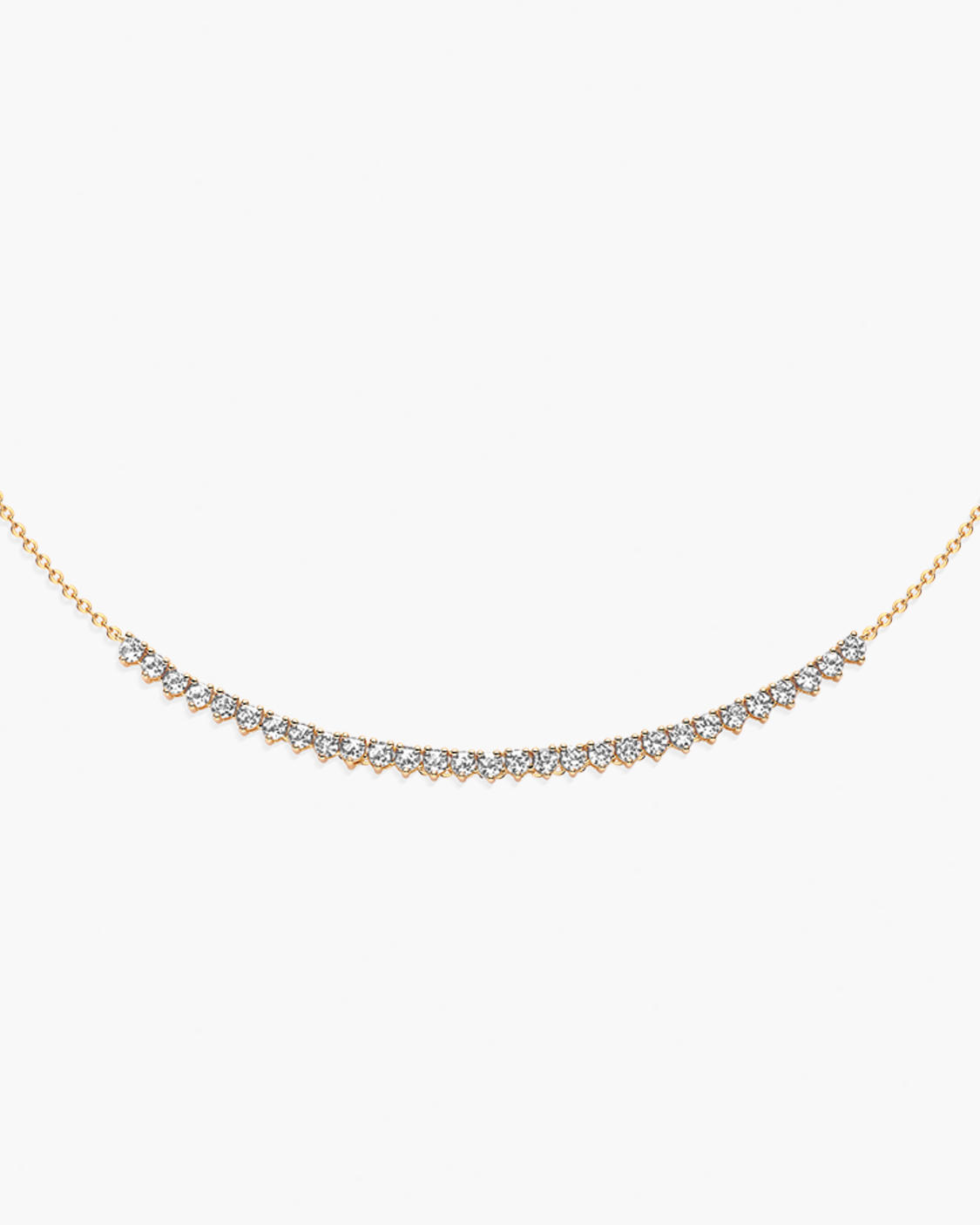 Gold necklace with small diamonds on a white background