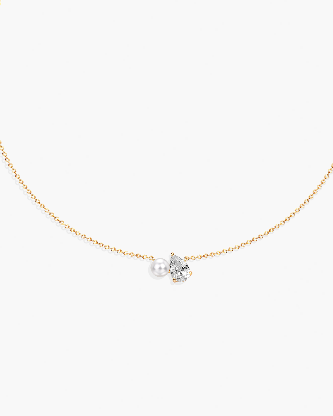 Delicate necklace with a pearl and small diamond on a white background